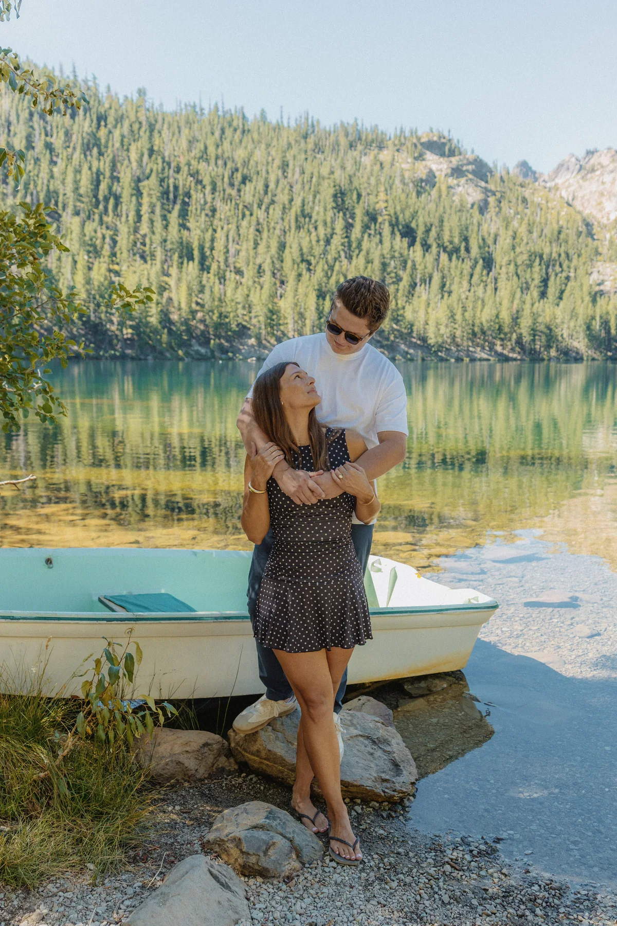 Couple embracing beside a small boat on Sardine Lake